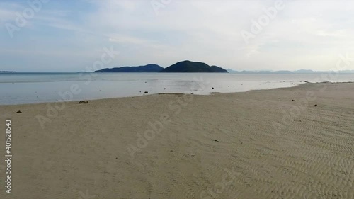 Drone flying fast pass the sea to the island
