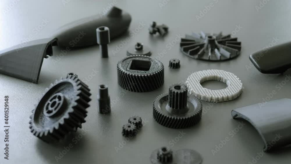 Close-up on the table are plastic models printed on a 3D printer in a scientific laboratory. 3d printing in action.