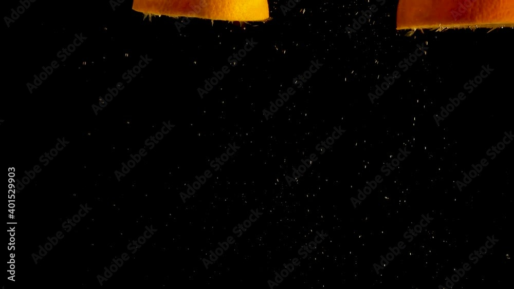 Orange halves falling, drop into water with air bubbles and a smooth black background. perfect for advertising or commercial videos for lemonade, juice and cocktails Also perfect for baar and drinks Orange halves falling, drop into water with air bubbles and a smooth black background. perfect for advertising or commercial videos for lemonade, juice and cocktails Also perfect for baar and drinks
