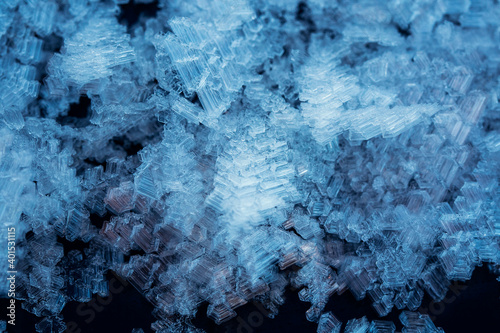 festive winter background with shiny white crystals of snowflakes and frost