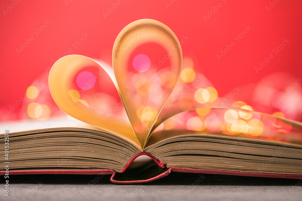 Book with love symbol on red background, heart shape from paper book. Book with love symbol on red background, heart shape from paper book.