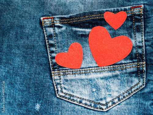 Red hearts on denim. Love symbol. Valentine's card. photo