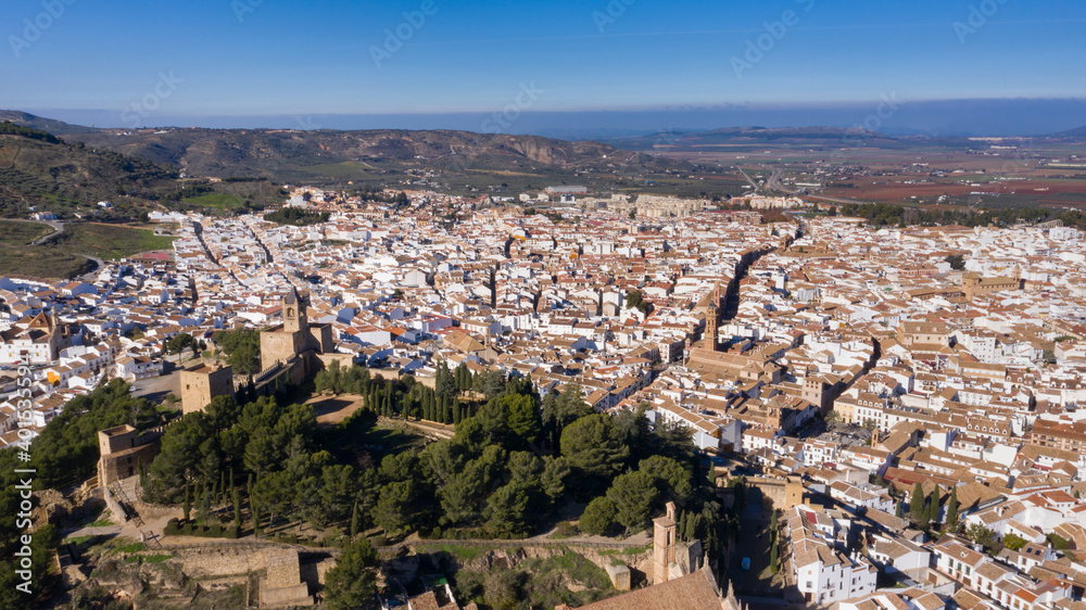Aerial panorama drone views of Antequera, typical Andalusian city with castle on a hill in south Spain