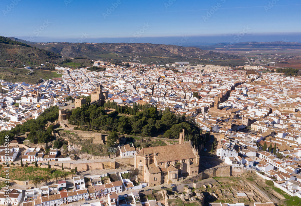 Bird view of Antequera, a white city in Andalusia, south Spain seen from above with castle and church