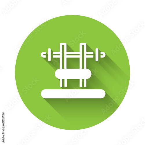White Bench with barbel icon isolated with long shadow. Gym equipment. Bodybuilding, powerlifting, fitness concept. Green circle button. Vector.