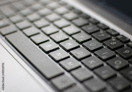 Laptop keyboard black on gray background. Close-up of laptop keyboard.