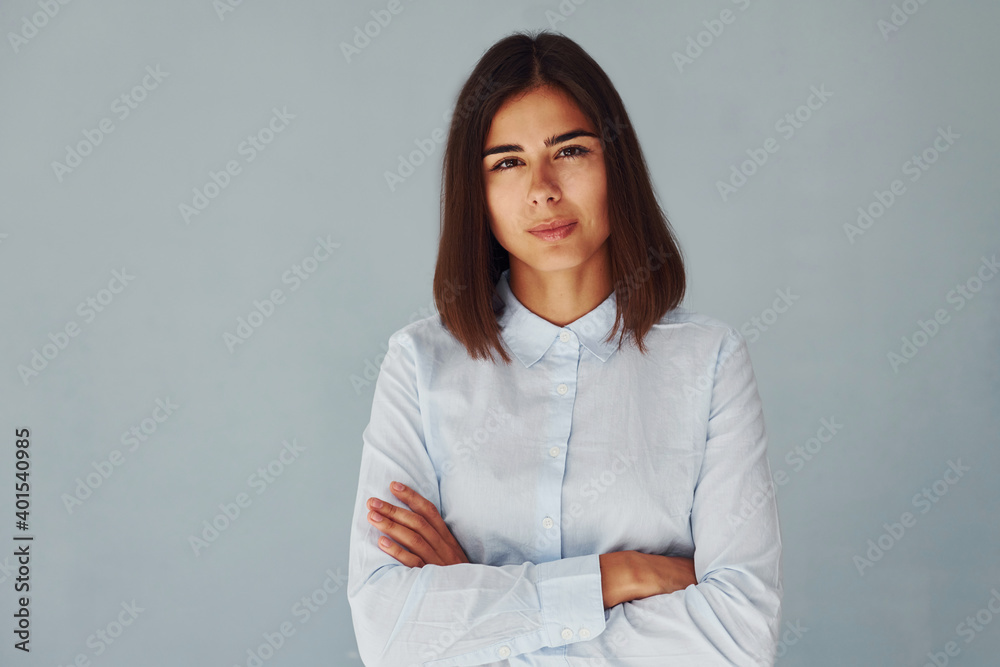 Young modern woman in white shirt standing inside of the studio Young modern woman in white shirt standing inside of the studio