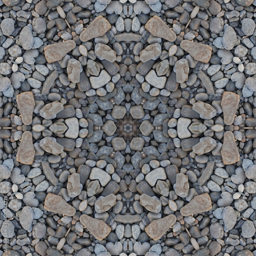 kaleidoscopic style of pebbles on a beach with colourful child's play fork and rake kaleidoscopic style of pebbles on a beach with colourful child's play fork and rake
