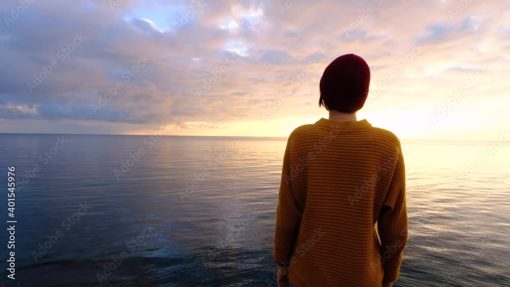 Young woman relaxing meditating alone on sea beach at colorful sky background. Stress overcome Young woman relaxing meditating alone on sea beach at colorful sky background. Stress overcome