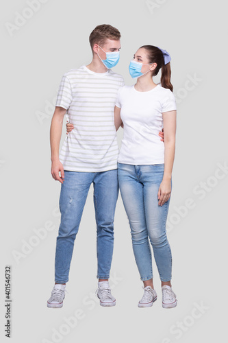 Couple Wearing Medical Mask Watching at Each Other Isolated. Man and Woman Hugging, Lovers, Friends, Couple, Virus Concept