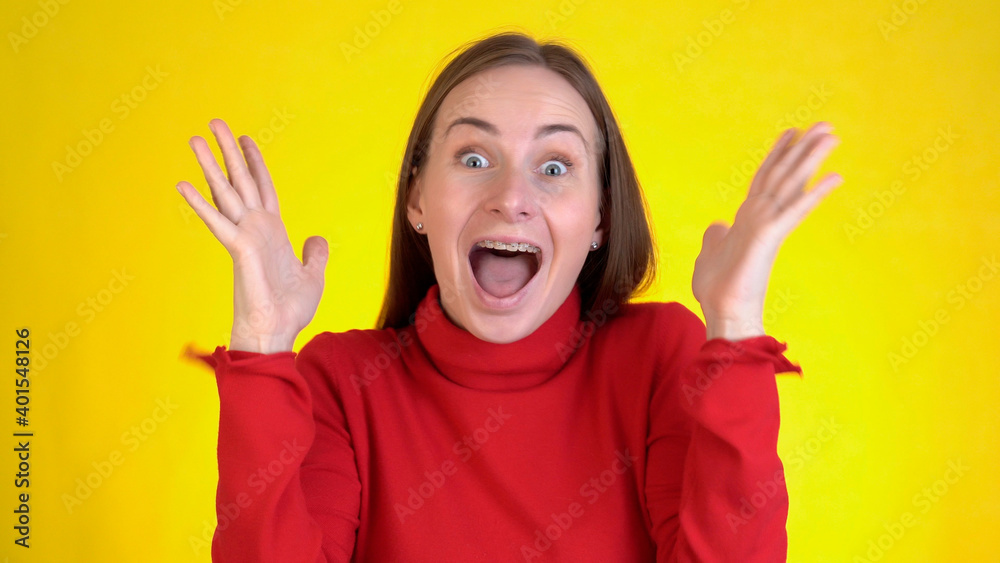 Close-up face of amazed woman shocked. Handsome girl surprised to camera over yellow background. Close-up face of amazed woman shocked. Handsome girl surprised to camera over yellow background.