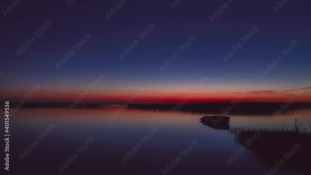 Beautiful sunset on flat lake with boat. Timelapse, time is accelerated Beautiful sunset on flat lake with boat. Timelapse, time is accelerated