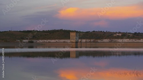 Lucefecit Dam in Terena with reflection on the lake reservoir at sunset, in Portugal photo