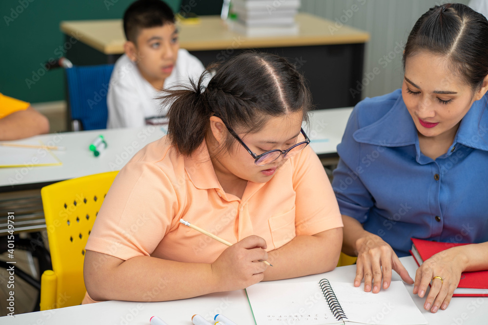 Asian Autism children with disability kid on wheelchair in special classroom with teacher. Asian Autism children with disability kid on wheelchair in special classroom with teacher.