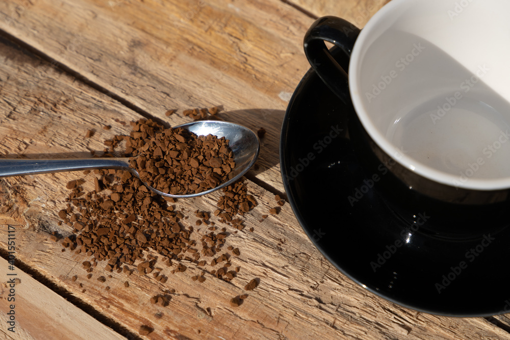 close up morning instant coffee with iron spoon and two biscuit cookies on a wooden table close up morning instant coffee with iron spoon and two biscuit cookies on a wooden table