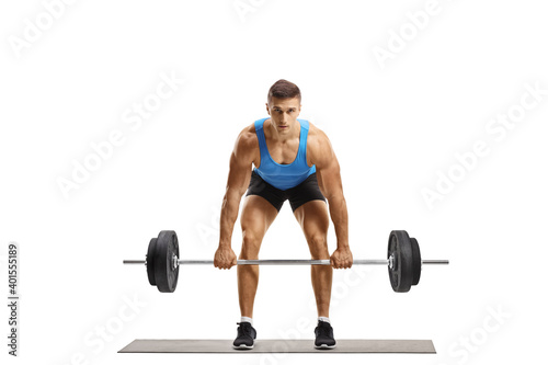 Strong guy lifting heavy weights and looking at camera