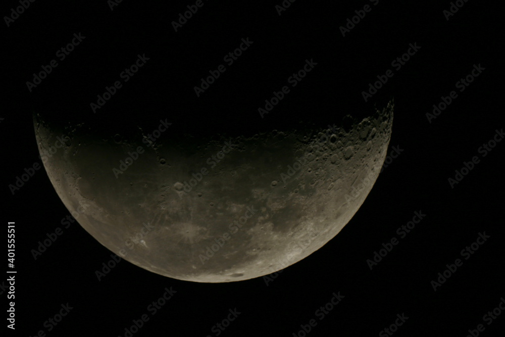 Astrophotography of the first quarter Moon taken with a camera fastened on a telescope Astrophotography of the first quarter Moon taken with a camera fastened on a telescope