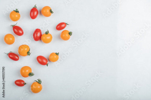 Close up photo of pile of cherry tomatoes on white background