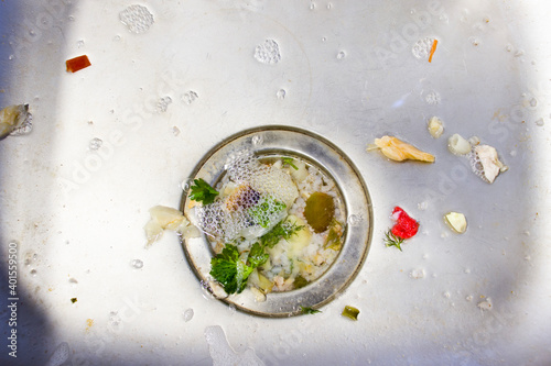 Close up on dirty clogging kitchen sink drain with food particles