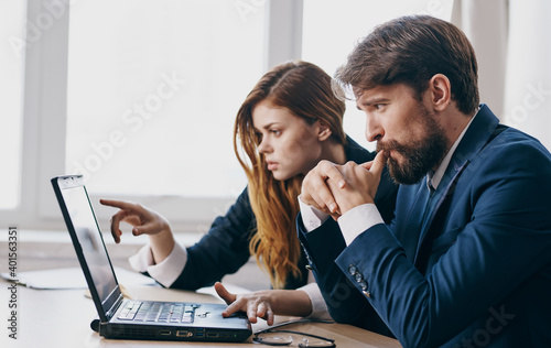 Man and woman in suits work laptop finance manager