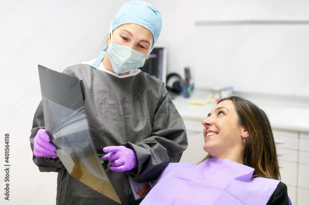 Doctor dentist showing patient's teeth on X-ray. High quality photo Doctor dentist showing patient's teeth on X-ray. High quality photo