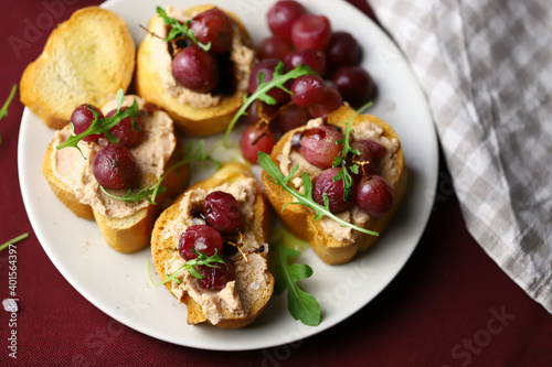 Selective focus. Toast with pate and grapes. French cuisine.