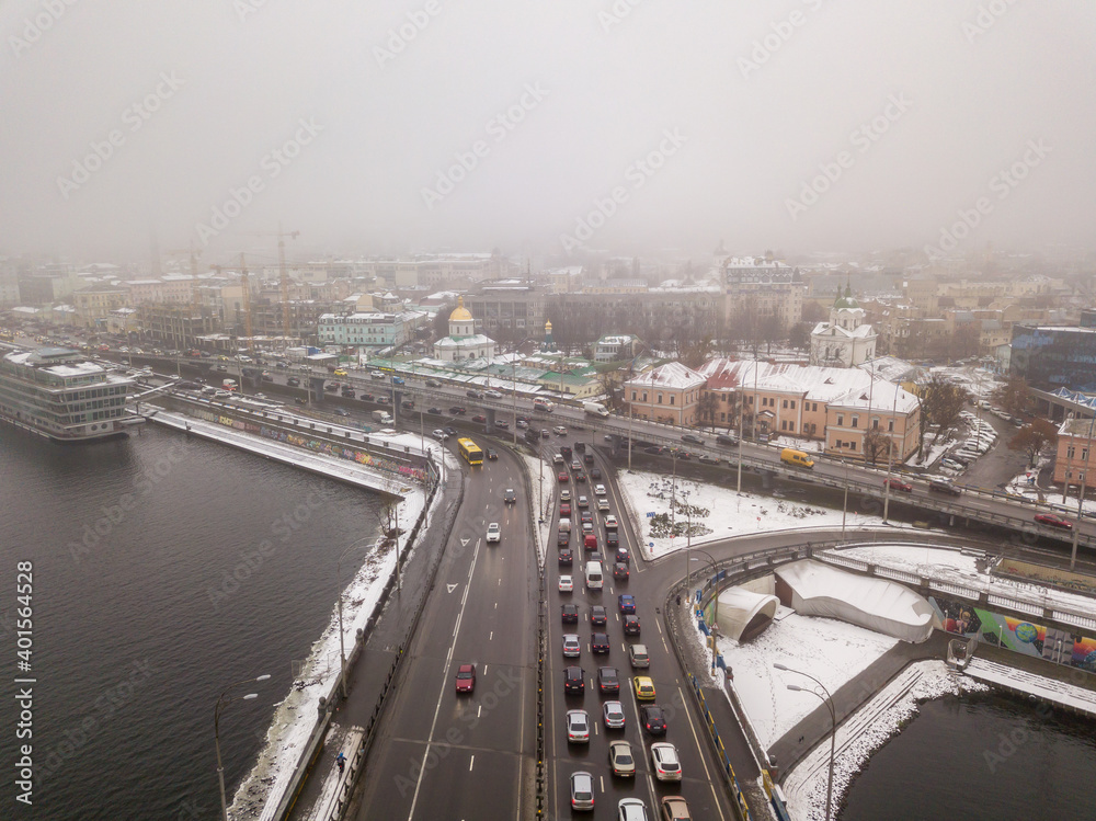 Aerial drone view. Automobile bridge over the Dnieper river in Kiev in the morning fog.