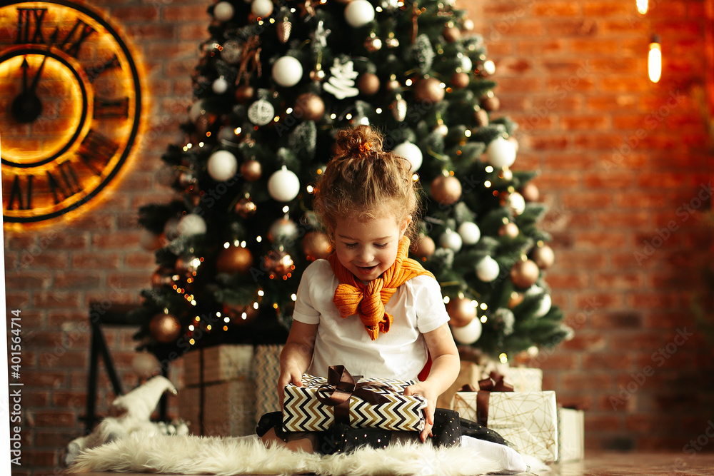 portrait of happy little girl with Christmas gifts .