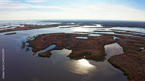Bird's-eye view of the beautiful Samarskie Plavni in the warm evening light in Ukraine. Aerial UHD 4K drone realtime video, shot in 10bit HLG and colorized