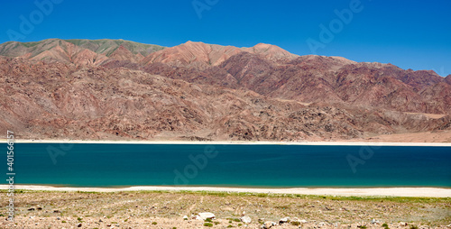 Orto Tokoy Reservoir in Kyrgyzstan with blue sky and azul water photo