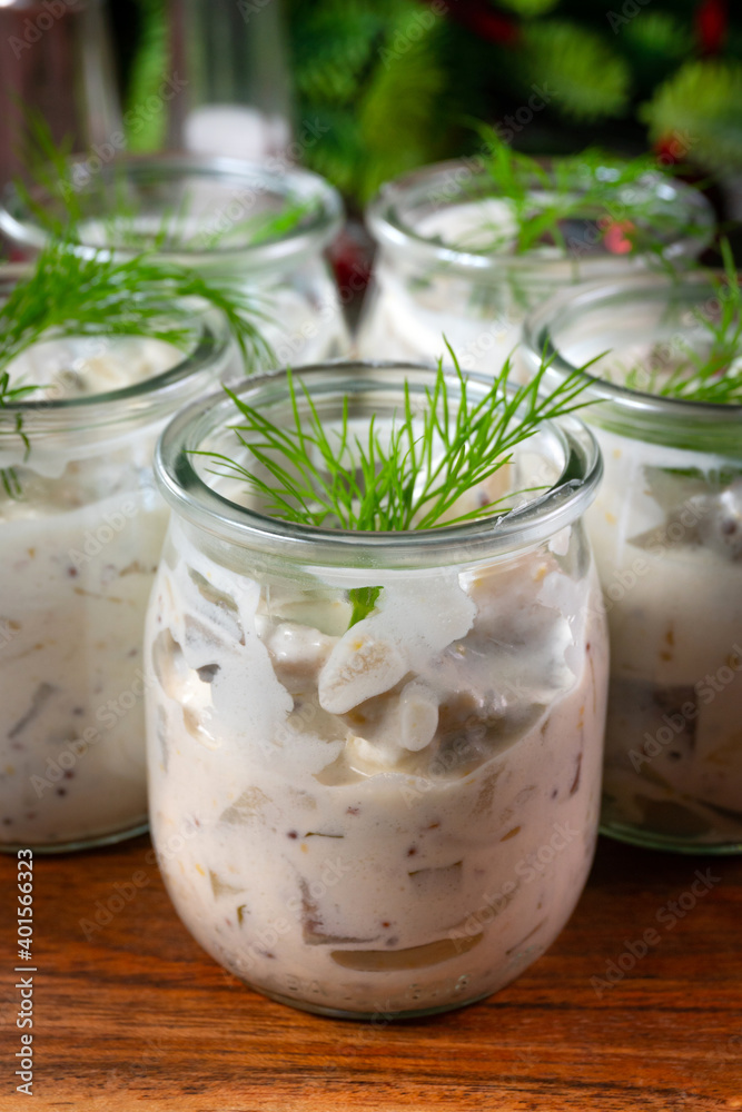 Pieces of herring in yoghurt with dill served in small jars. Pieces of herring in yoghurt with dill served in small jars.