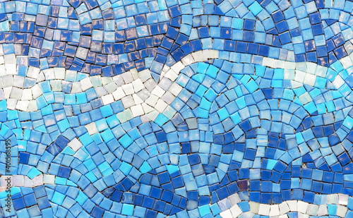Ceramic mosaic tiles with white  blue and dark blue squares  laid out in a chaotic manner.