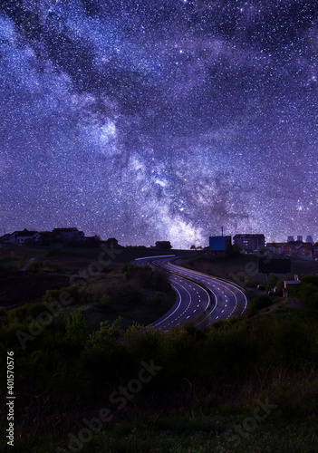 Empty E-75 highway making S curve through Belgrade, Serbia at night with the stary sky and milky way. Long exposure of highway and milky way. photo