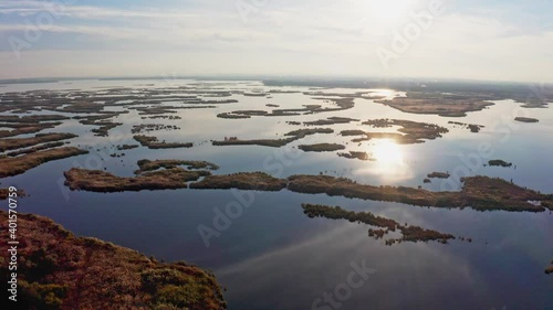 Bird's-eye view of the beautiful Samarskie Plavni in the warm evening light in Ukraine. Aerial UHD 4K drone realtime video, shot in 10bit HLG and colorized