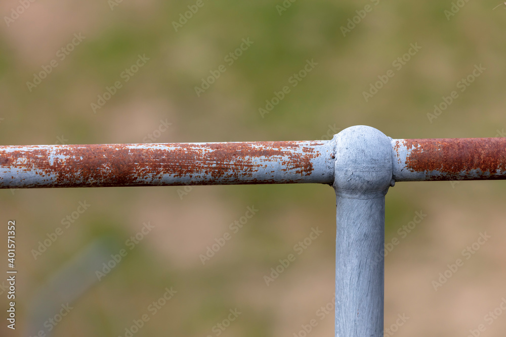 A rusty steel fence post and hand rail A rusty steel fence post and hand rail