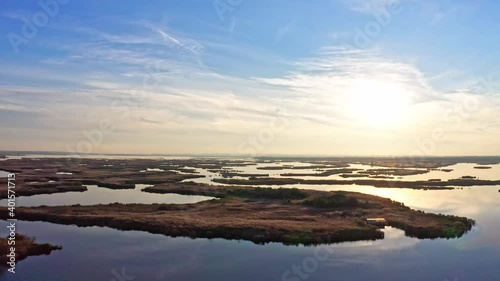 Bird's-eye view of the beautiful Samarskie Plavni in the warm evening light in Ukraine. Aerial UHD 4K drone realtime video, shot in 10bit HLG and colorized