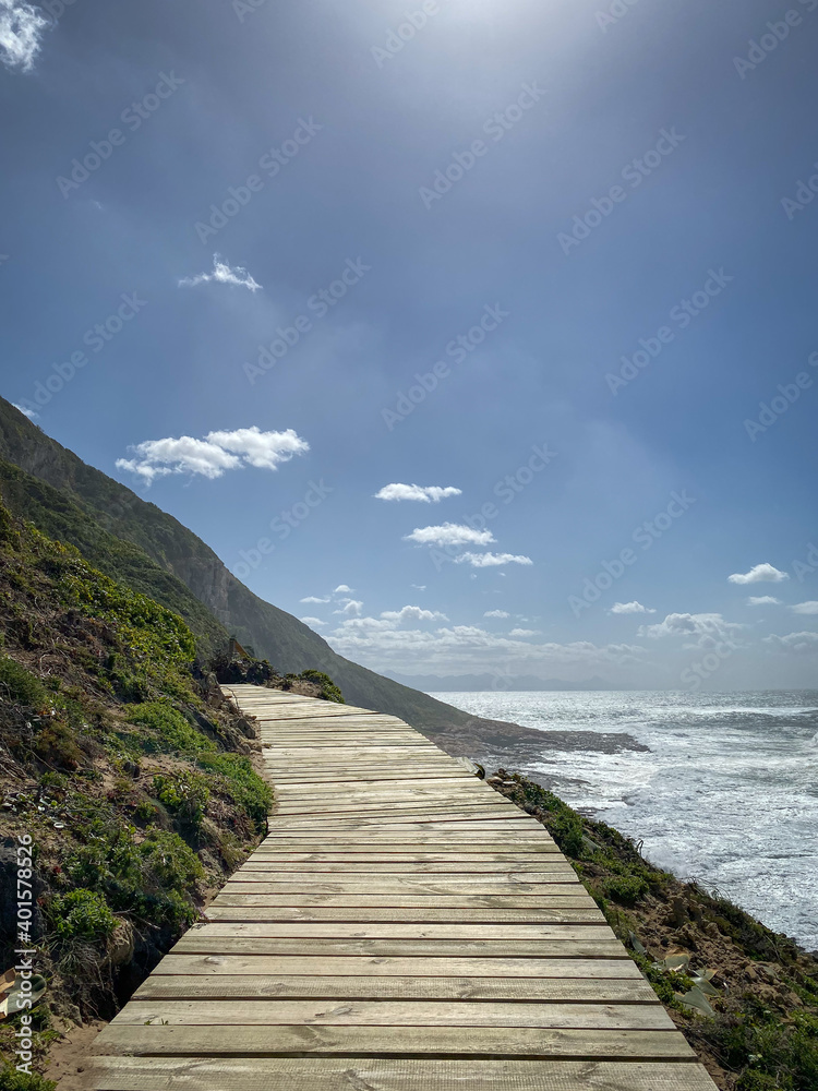 Scenic view of wooden footpath along hiking trail at Robberg Nature Reserve, Plettenberg Bay, South Africa.
