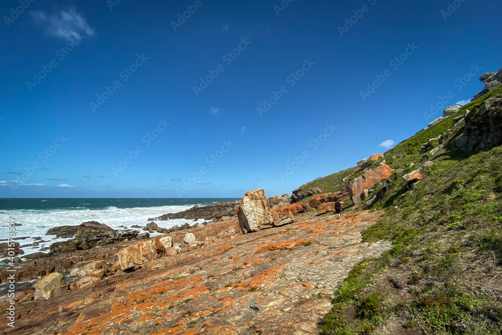 Woman walking on hiking trail at Robberg Nature Reserve, Plettenberg Bay, South Africa.