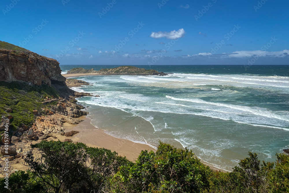 Scenic view of sandy beach and rocks at Robberg Nature Reserve, Plettenberg Bay, South Africa.