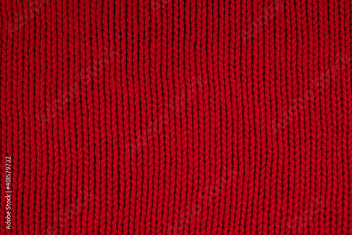 background of red knitted fabric close up