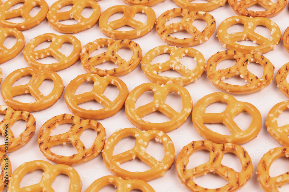 White background filled with neatly laid out salty crackers close-up White background filled with neatly laid out salty crackers close-up
