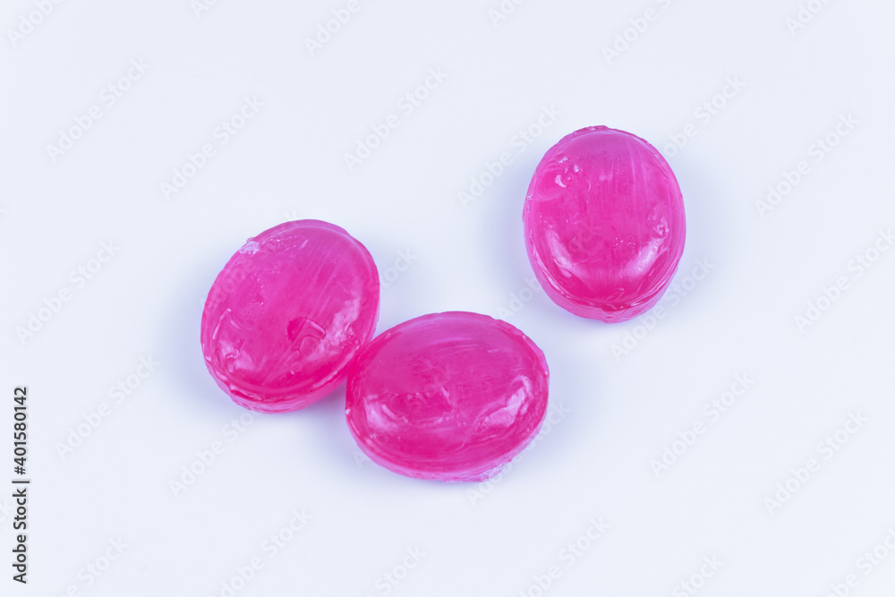Three caramels of the same pink color on a white background Three caramels of the same pink color on a white background