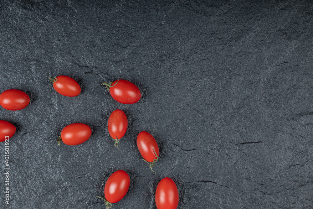 Close up photo of Small cherry tomatoes on black background
