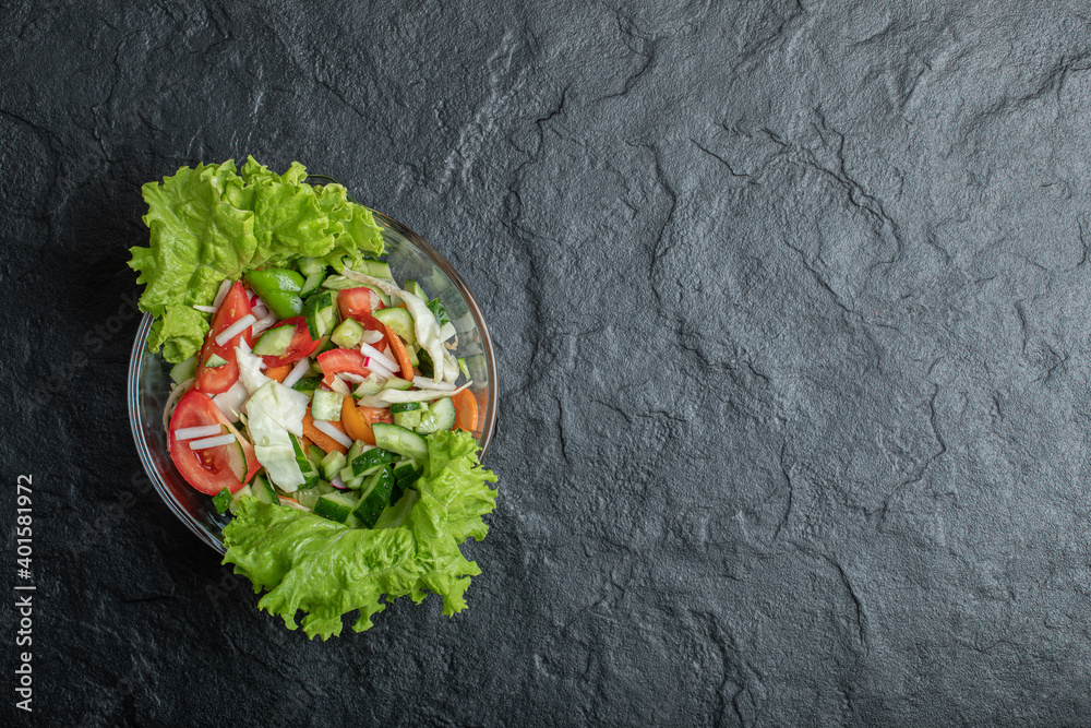Healthy vegetable salad of fresh tomato, cucumber, onion on plate.