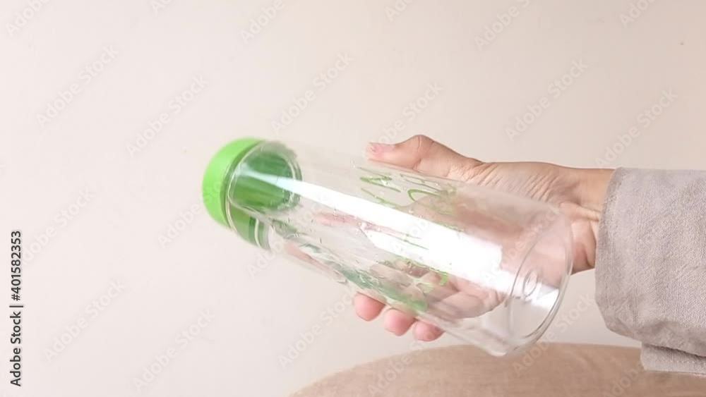 shaking a green bottle drink with a white background shaking a green bottle drink with a white background