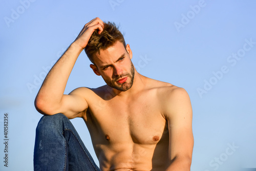 Sexy pensive man relaxing outdoors. Male beauty. Fashion guy. Attractive and mysterious. Athletic handsome macho. Muscular body. Muscular chest. Muscular bare torso. Summer season. Fitness model