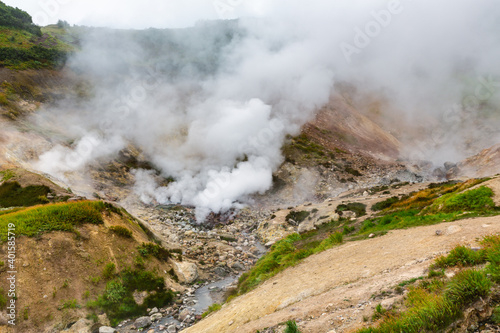 Breathtaking scenery view of volcanic landscape, aggressive hot spring, eruption fumarole, gas-steam activity in crater of active volcano. Stunning mountain landscape, travel destinations for hiking.