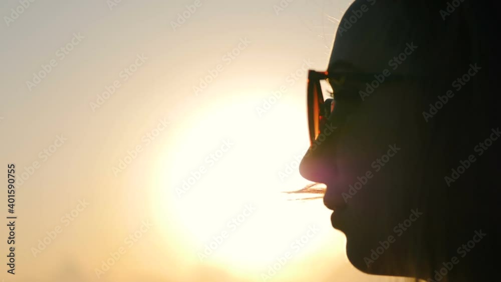 Fluttering hair. Girl on the sea at sunset