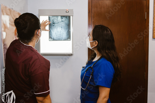 Hispanic women doctor and nurse working with radiography in a Mexican hospital
