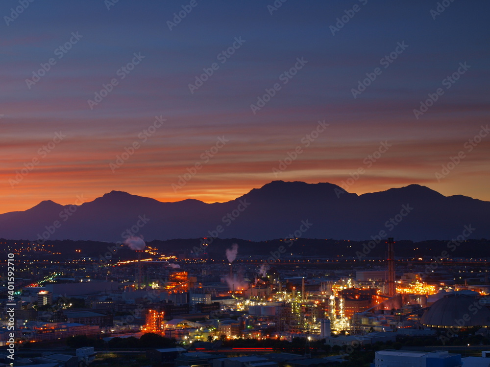 factories and mountain silhouettes at dawn